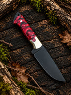 Black D2 steel skinner knife with red pinecone handle and leather sheath - angle 2