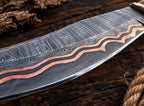 Copper Damascus clip point blade with copper edge lining close-up