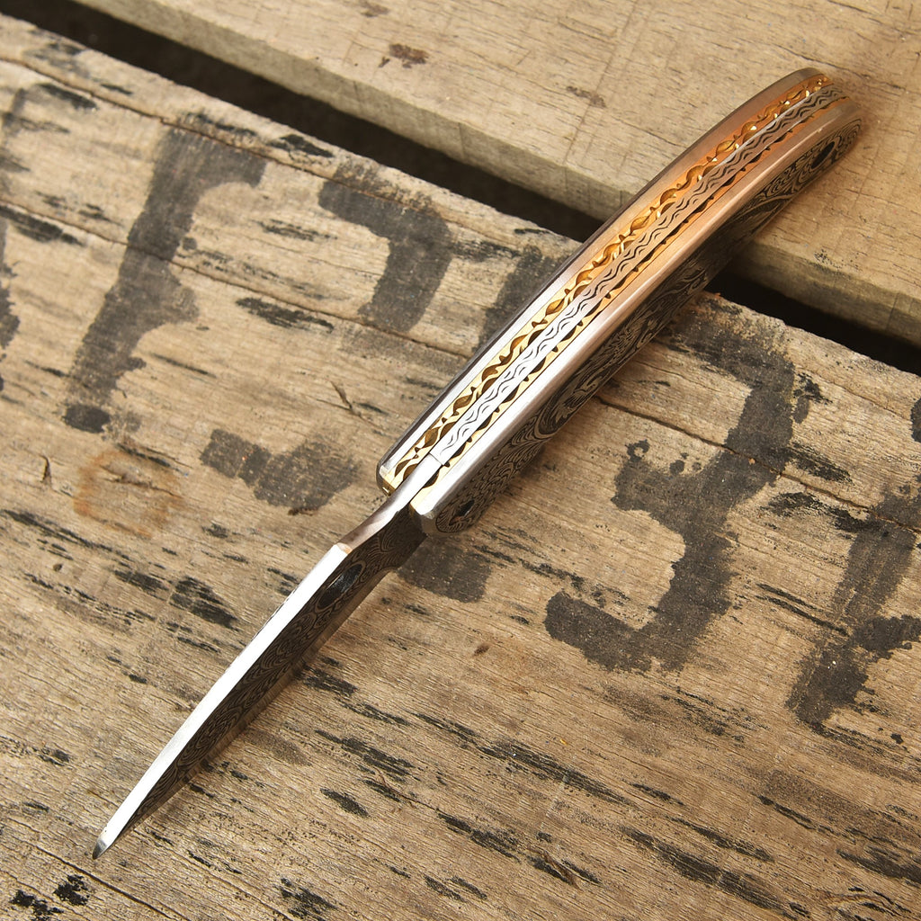 Custom engraved Damascus folding knife closed view
