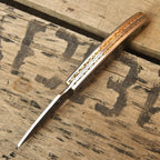 Custom engraved Damascus folding knife closed view