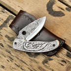 Close-up of custom engraving on Damascus knife