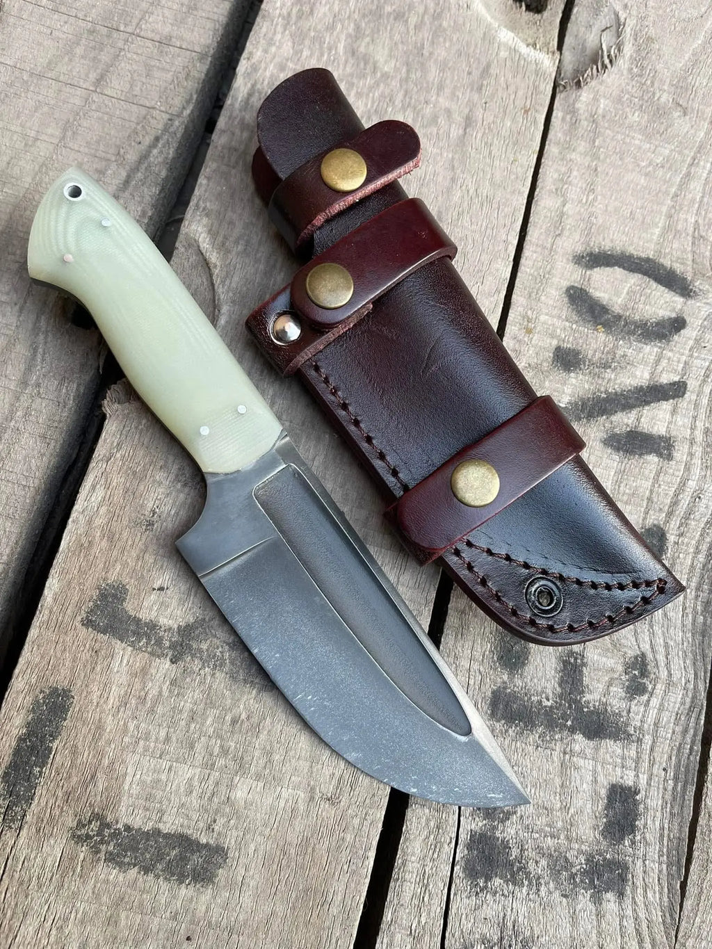 Acid wash D2 steel blade with fuller close-up on skinner knife