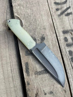 Pale cream G10 handle scales with pins and lanyard hole detail