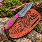 D2 steel drop point blade close-up on pink wood handle cowboy knife