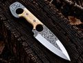 Handmade D2 steel double finger hole knife with Celtic Viking engraving and white bone handle - full view with Italian leather sheath