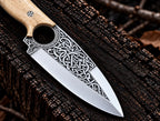 D2 steel Celtic Viking engraved knife with white bone handle on wood background - full length view