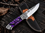 Hand engraved bear and floral scrollwork on mirror polished D2 steel blade close-up