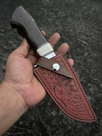 Satin polished D2 steel drop point blade with steel finger guard close-up