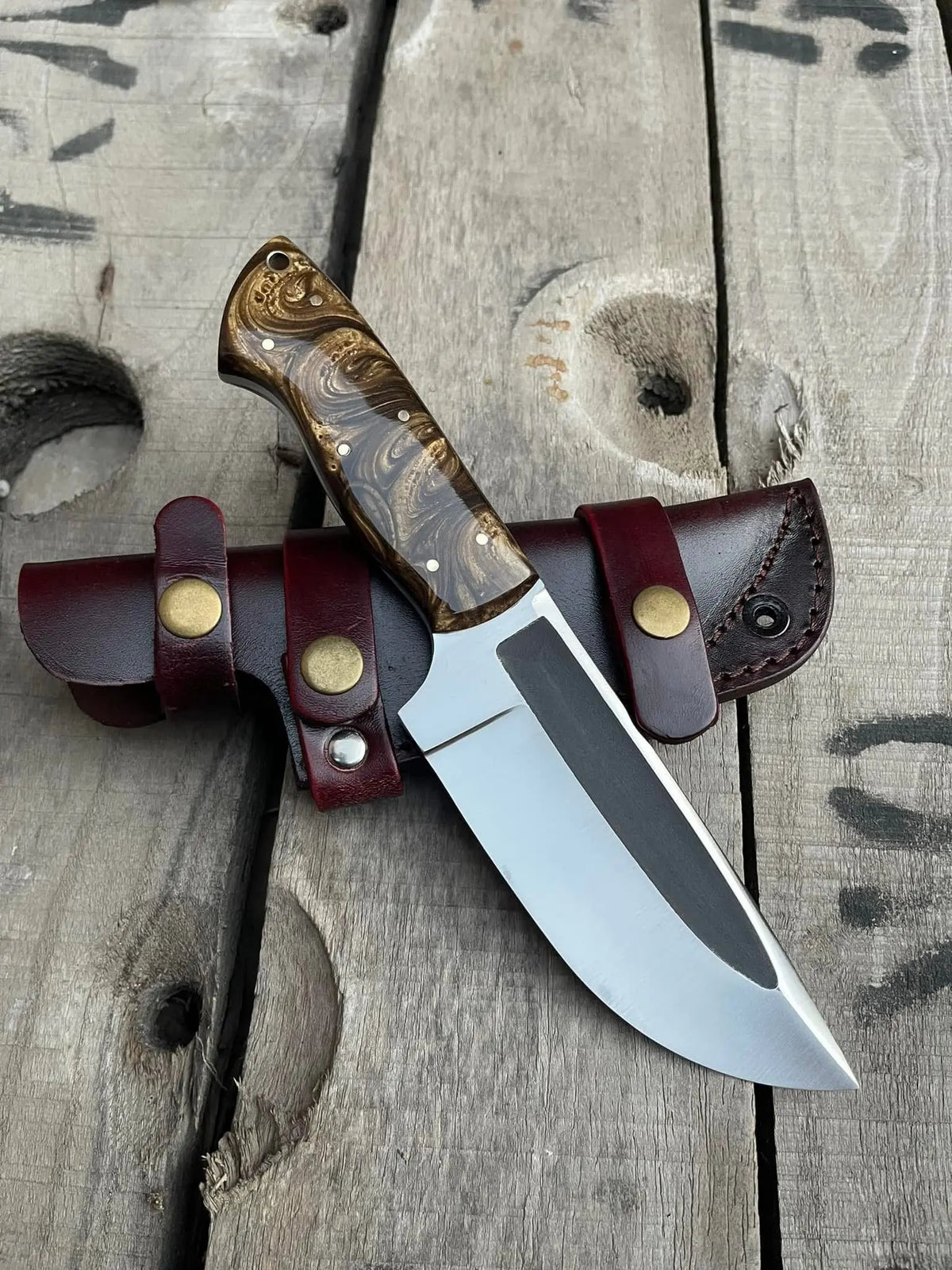 Handmade D2 steel full tang skinner knife with brown and golden resin handle and horizontal Italian leather sheath - full view