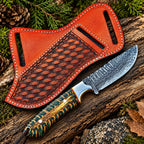 Handmade Damascus steel cowboy knife with green and gold handle and tooled leather sheath