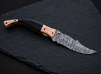 Damascus steel fire pattern blade close-up on folding knife