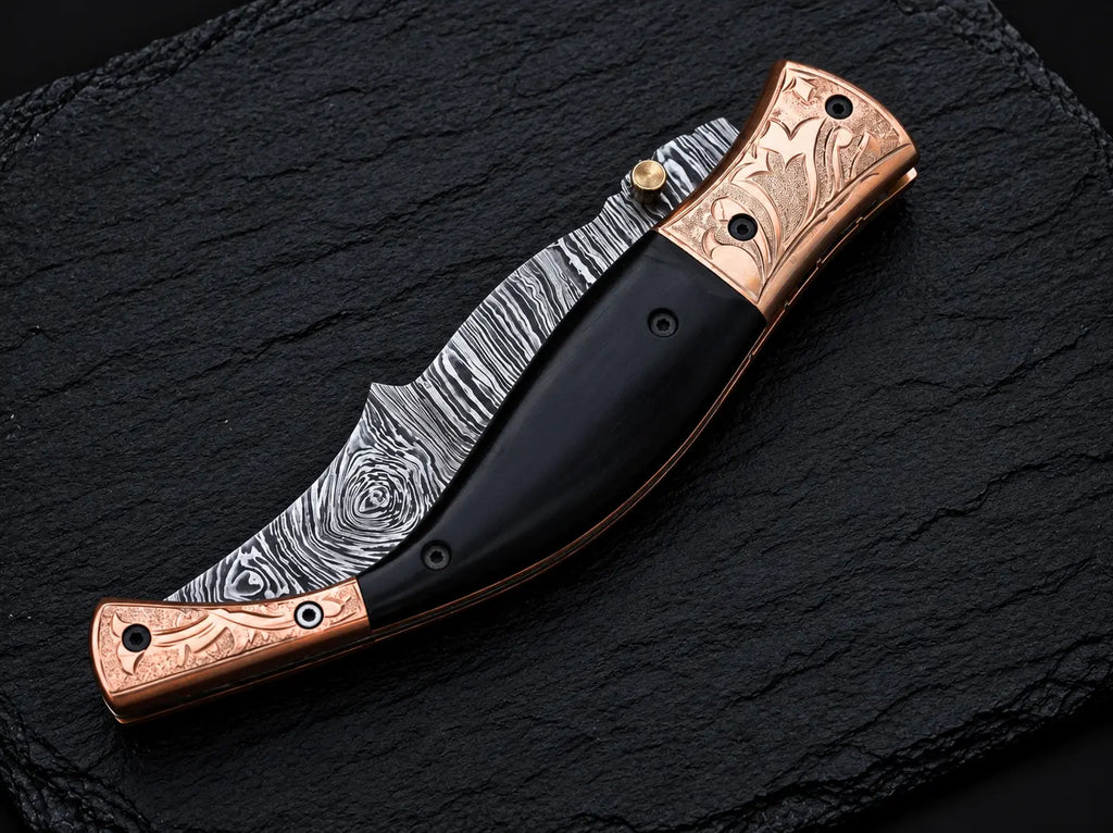 Black buffalo horn handle and brass thumb stud detail