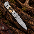 Stag antler handle detail on Damascus folding knife