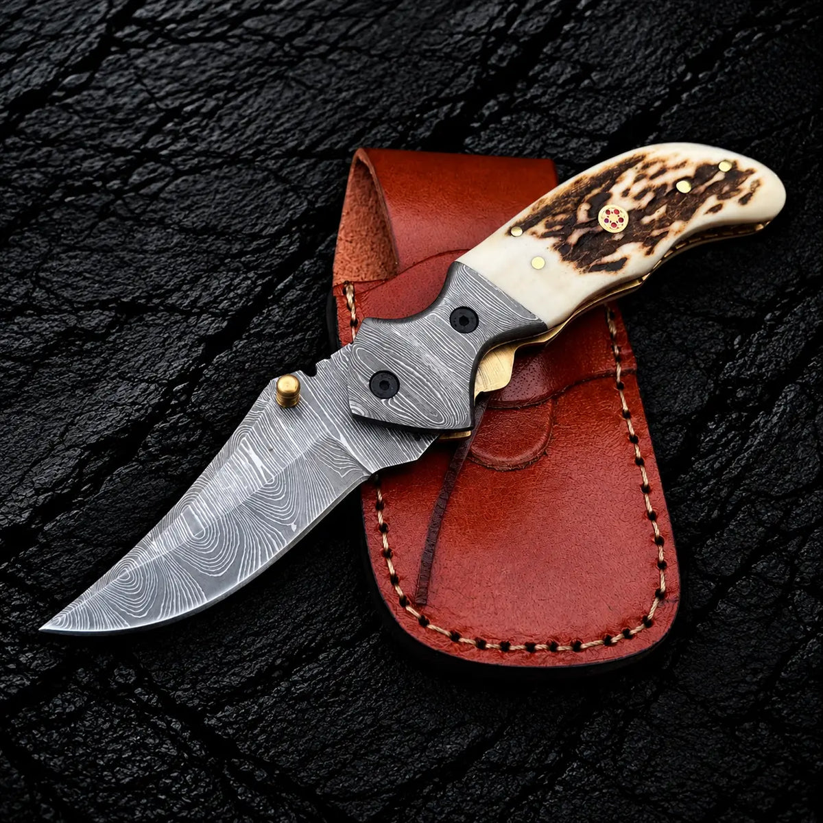 Handmade Damascus folding knife with stag horn handle, liner lock and Italian leather pouch - full view