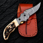 Damascus bolsters with screws and brass liners on liner lock folding knife