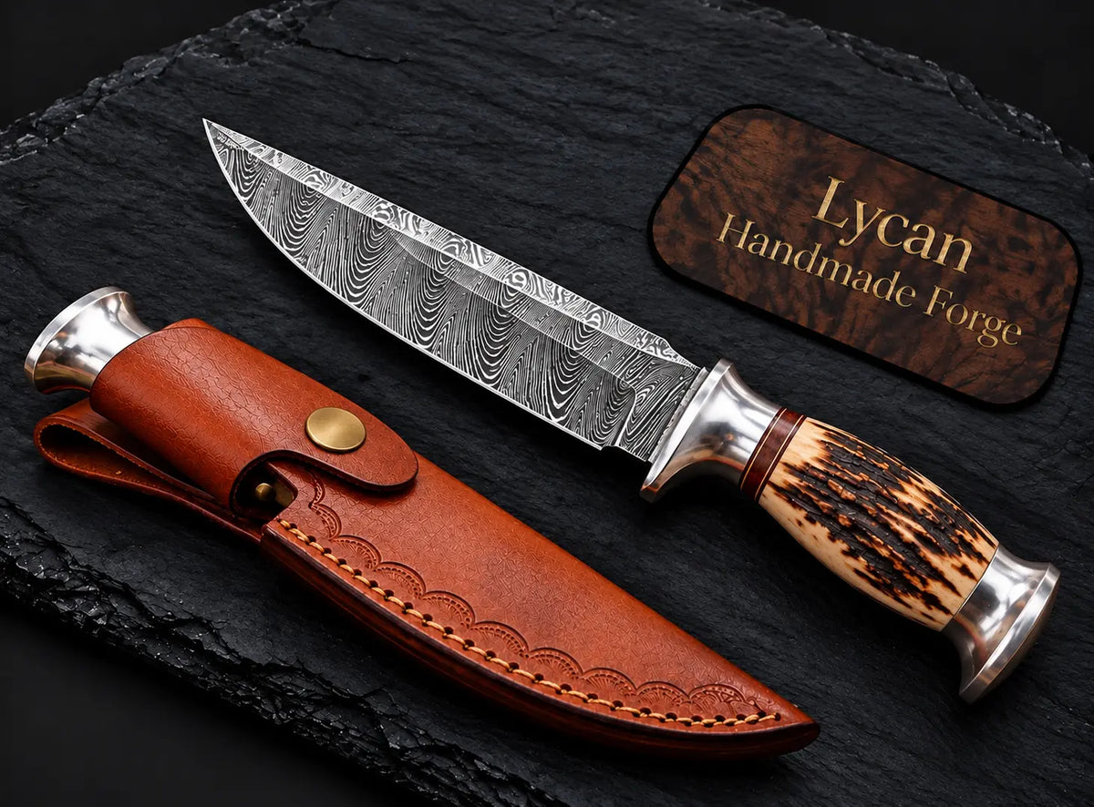Stag antler handle with silver guard and pommel detail on Damascus knife