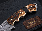 Stag antler handle with finger groove detail on gut hook skinner knife
