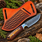Handmade Damascus steel skinner knife with purple and gold handle and tooled leather sheath