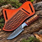 Damascus steel drop point blade close-up on skinner knife with purple handle