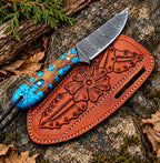 Handmade Damascus steel skinner knife with turquoise inlay handle and floral leather sheath - full view