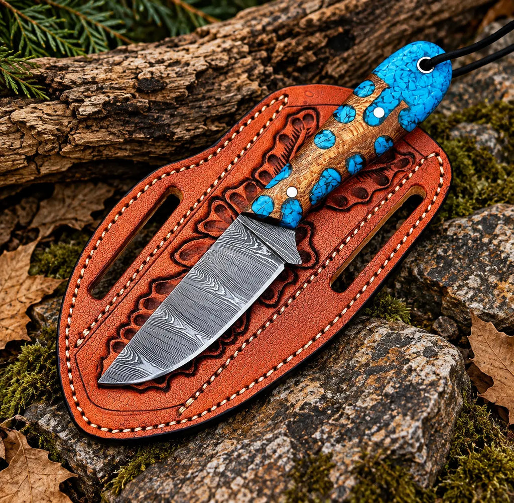 Damascus steel drop point blade close-up on turquoise inlay skinner knife