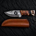 Handmade Damascus skinner knife with wire-cut deer head design and stag horn handle - full view with leather sheath