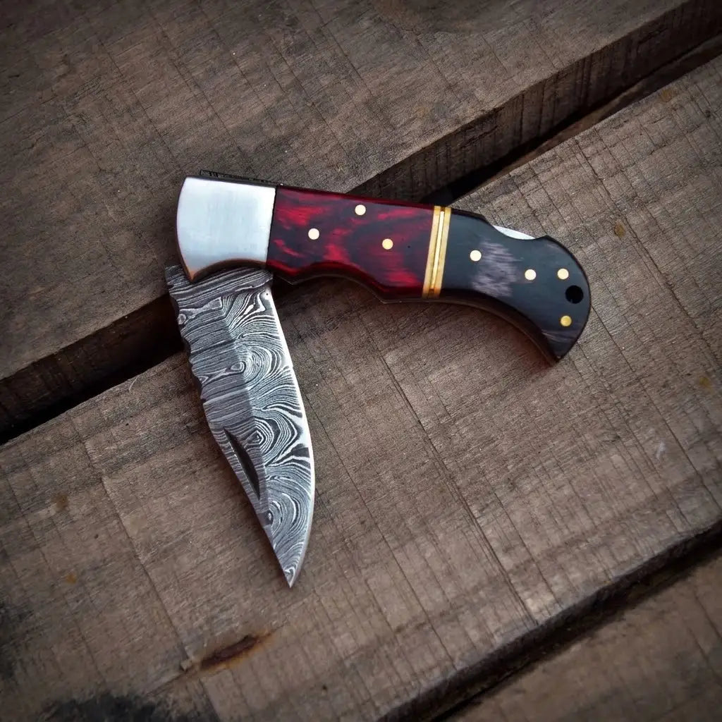 Close-up of hand-forged Damascus steel folding knife blade pattern