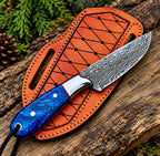 Blue resin handle detail with red liner on Damascus skinner knife