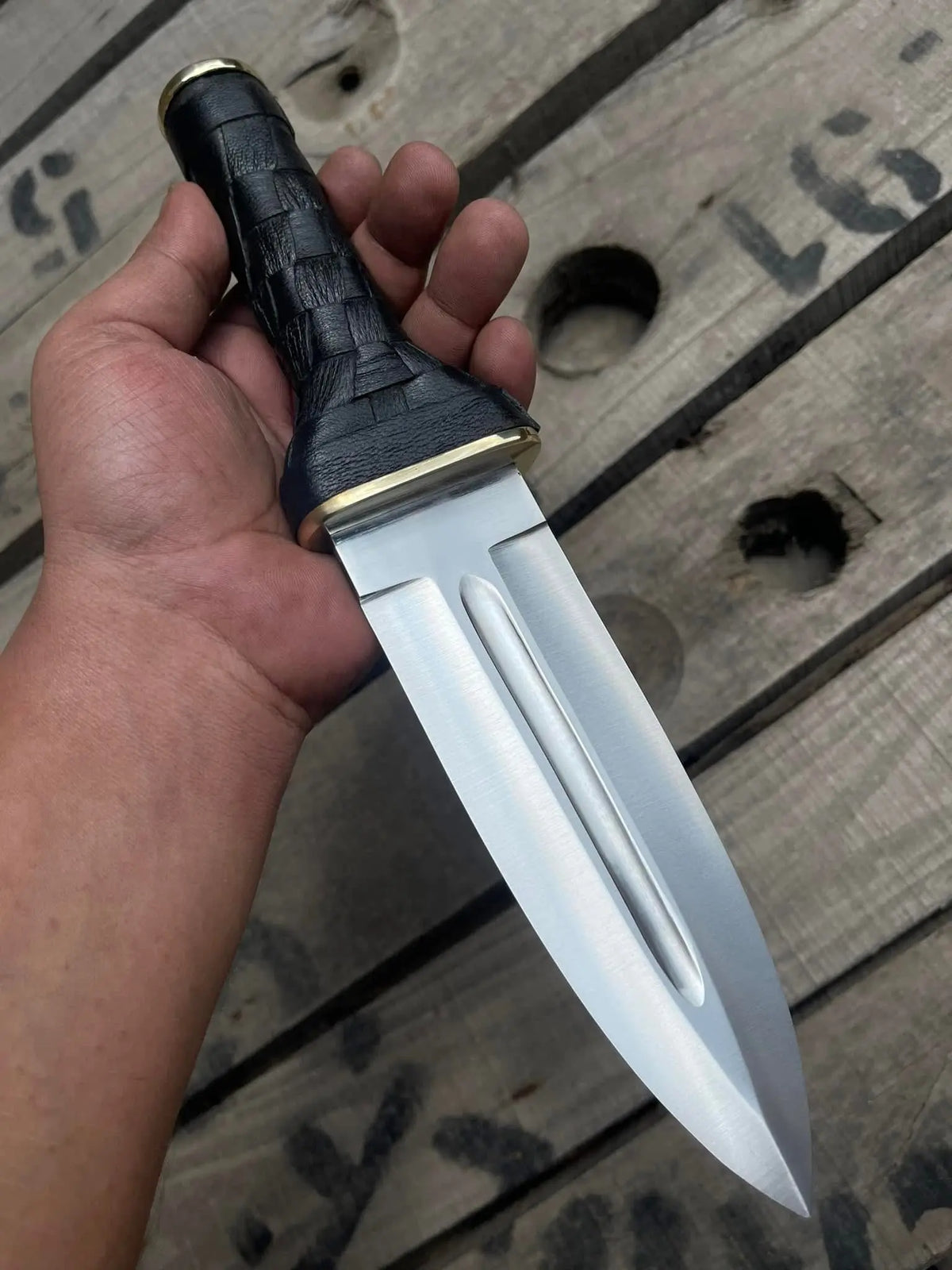 Double edge dagger blade close-up showing centered fuller