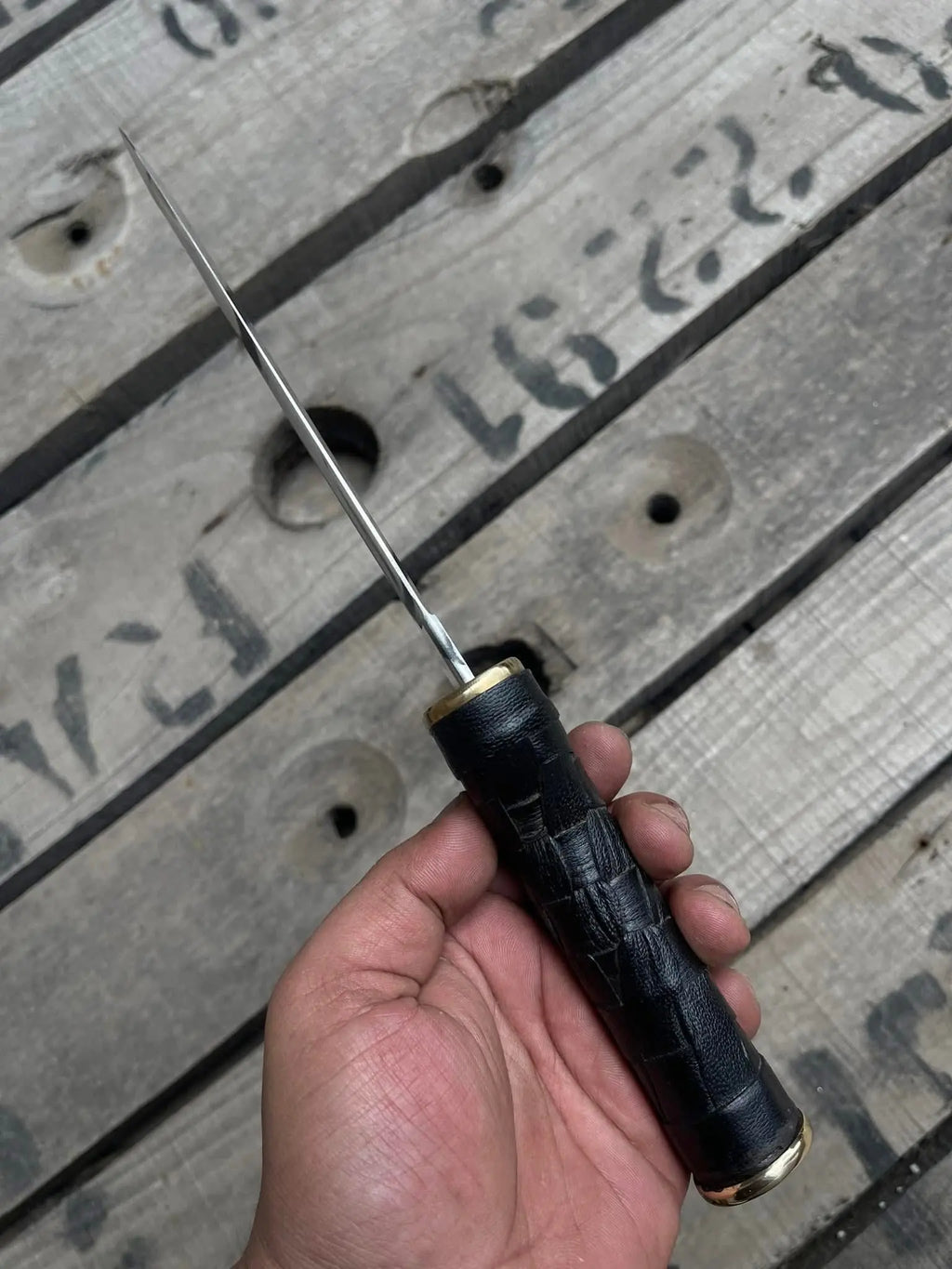 Black woven texture wrapped handle detail on dagger knife