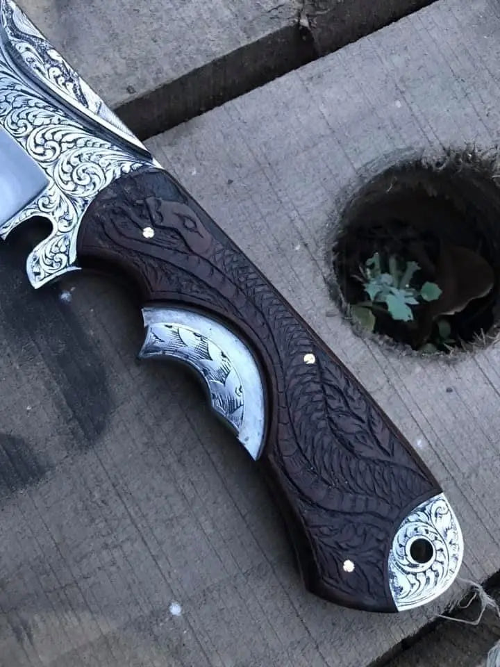 Carved wood handle detail on hand engraved Bowie knife