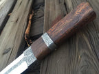 Carved wood handle with crosshatch grip detail on engraved knife