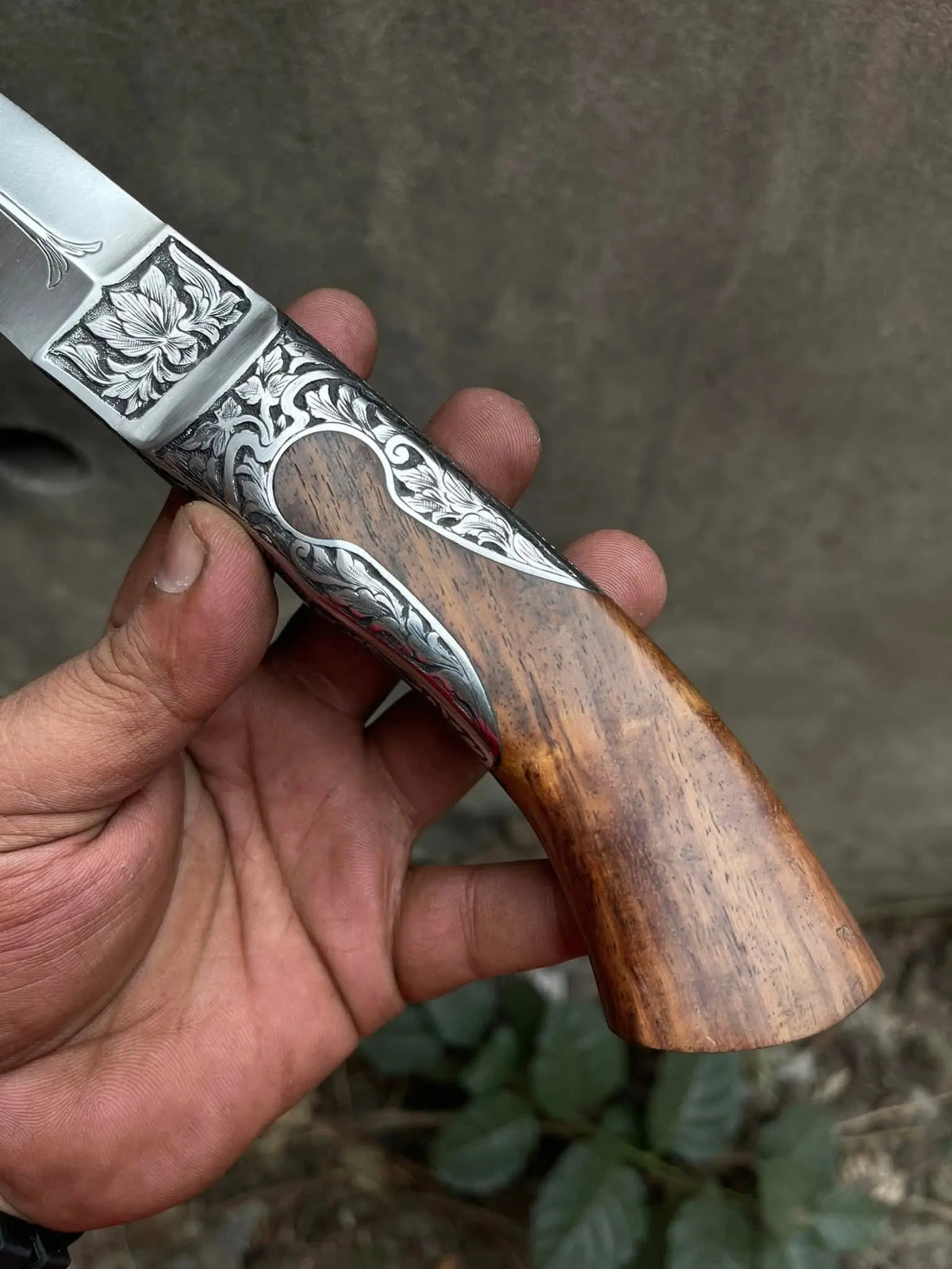 Wood handle detail on hand engraved fixed blade knife