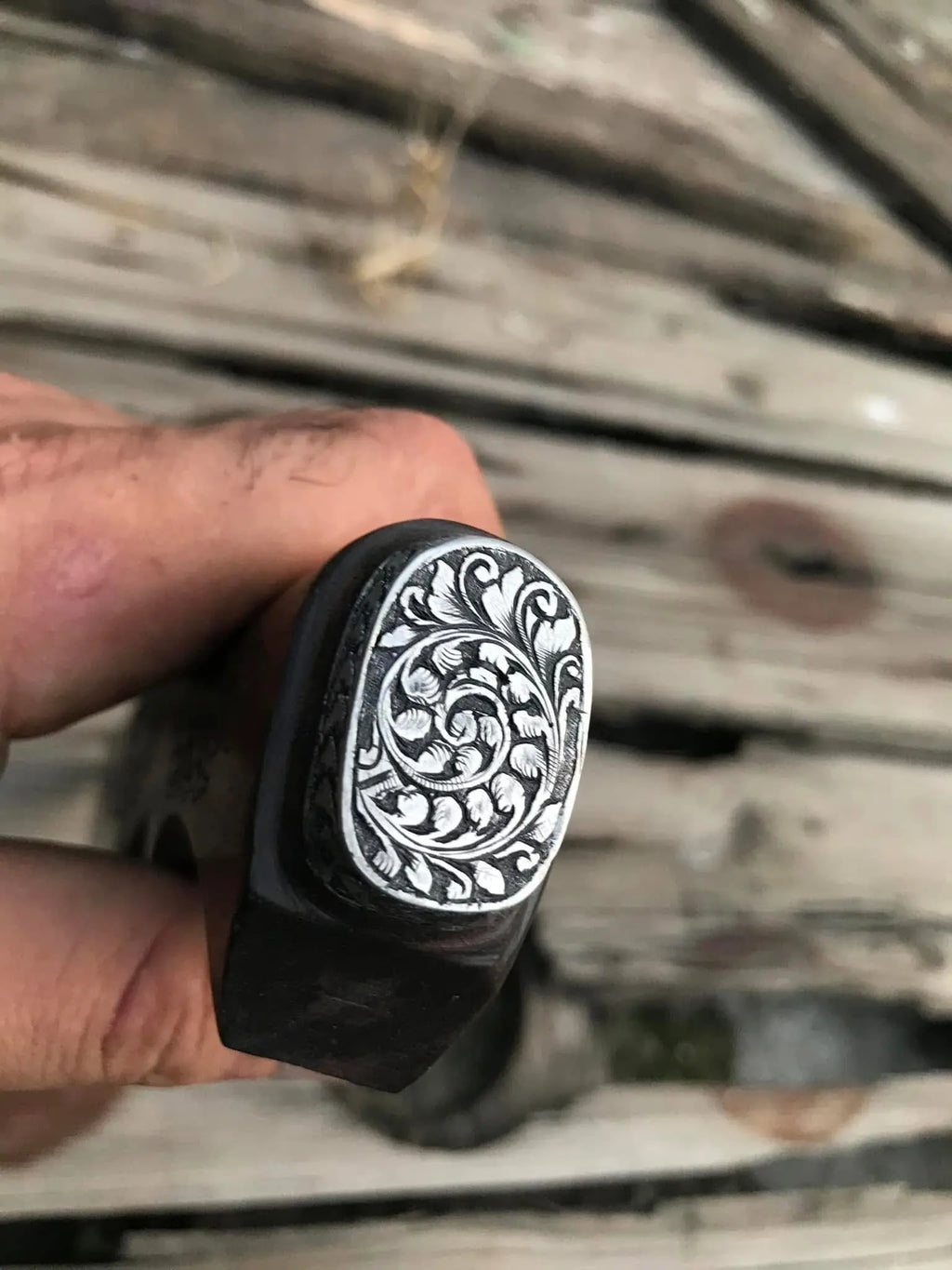Hand engraved bird design close-up on skinner knife blade