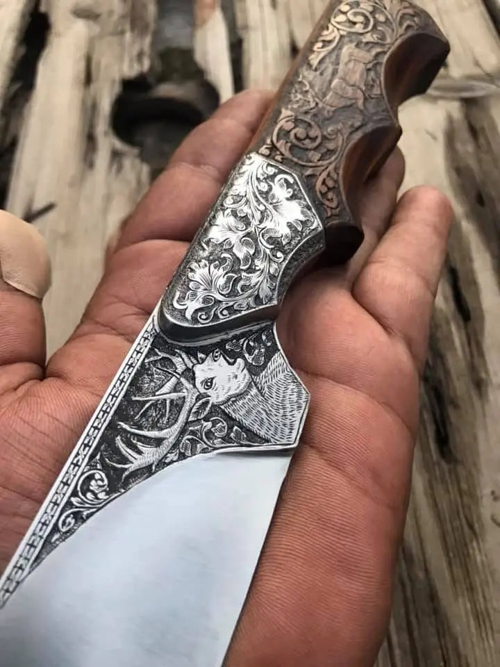 Carved wood handle with finger groove detail on engraved skinner knife