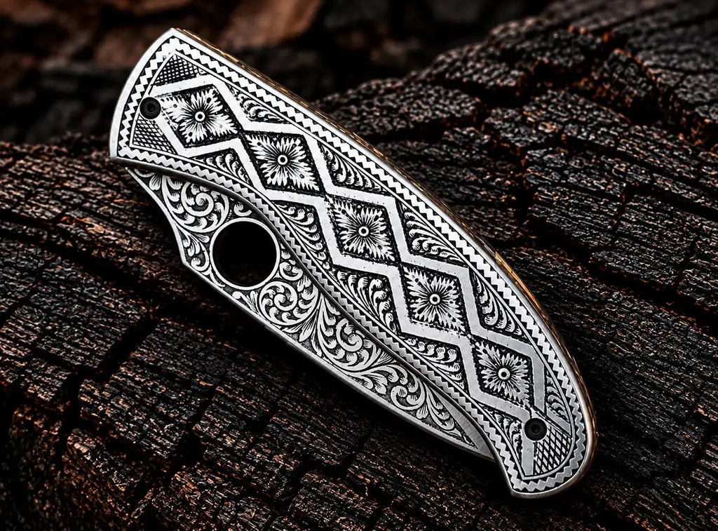 Round thumb hole on engraved steel folding knife blade
