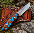Mirror polished drop point blade close-up with file-worked spine on turquoise handle skinner knife