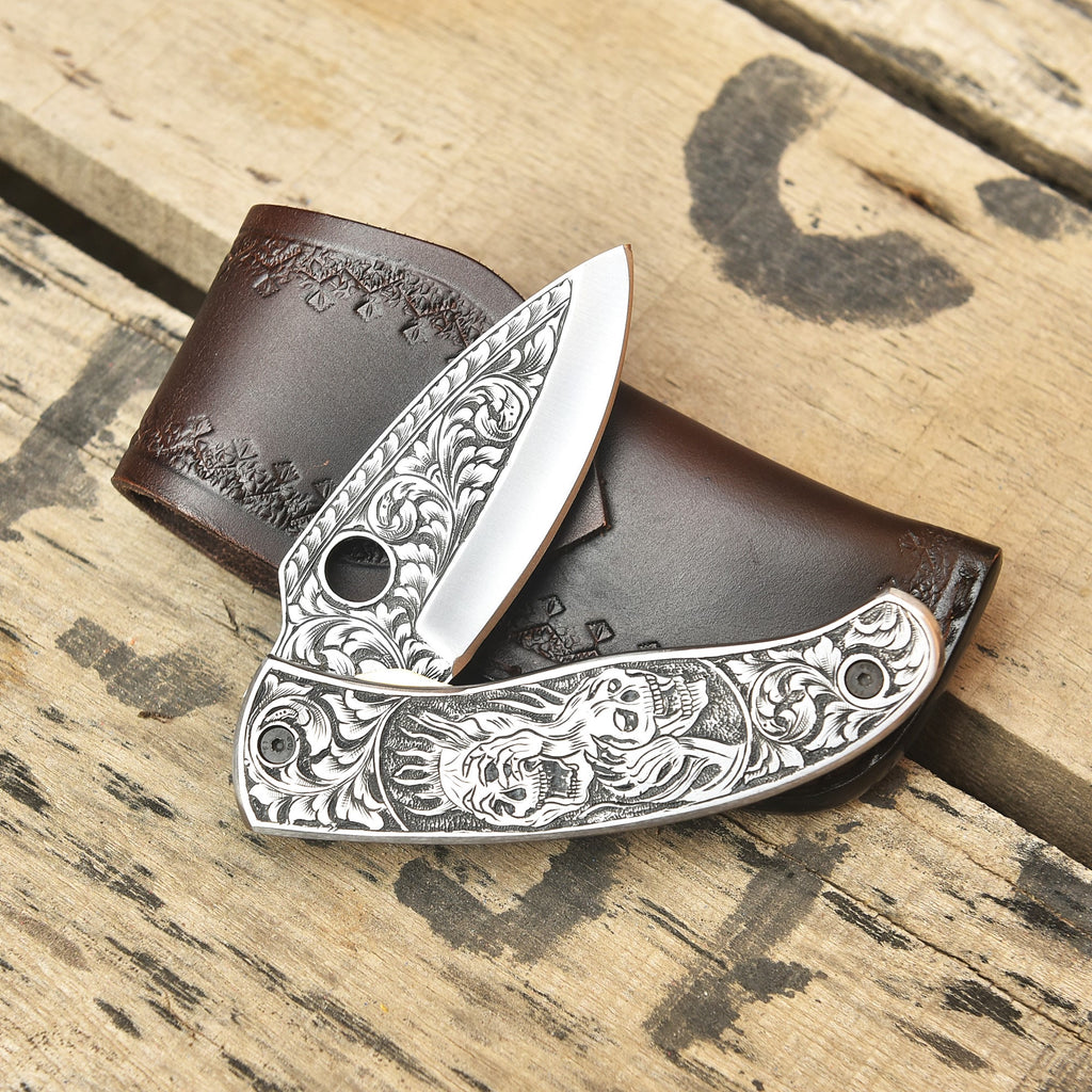 Skull engraved folding knife open, Damascus blade