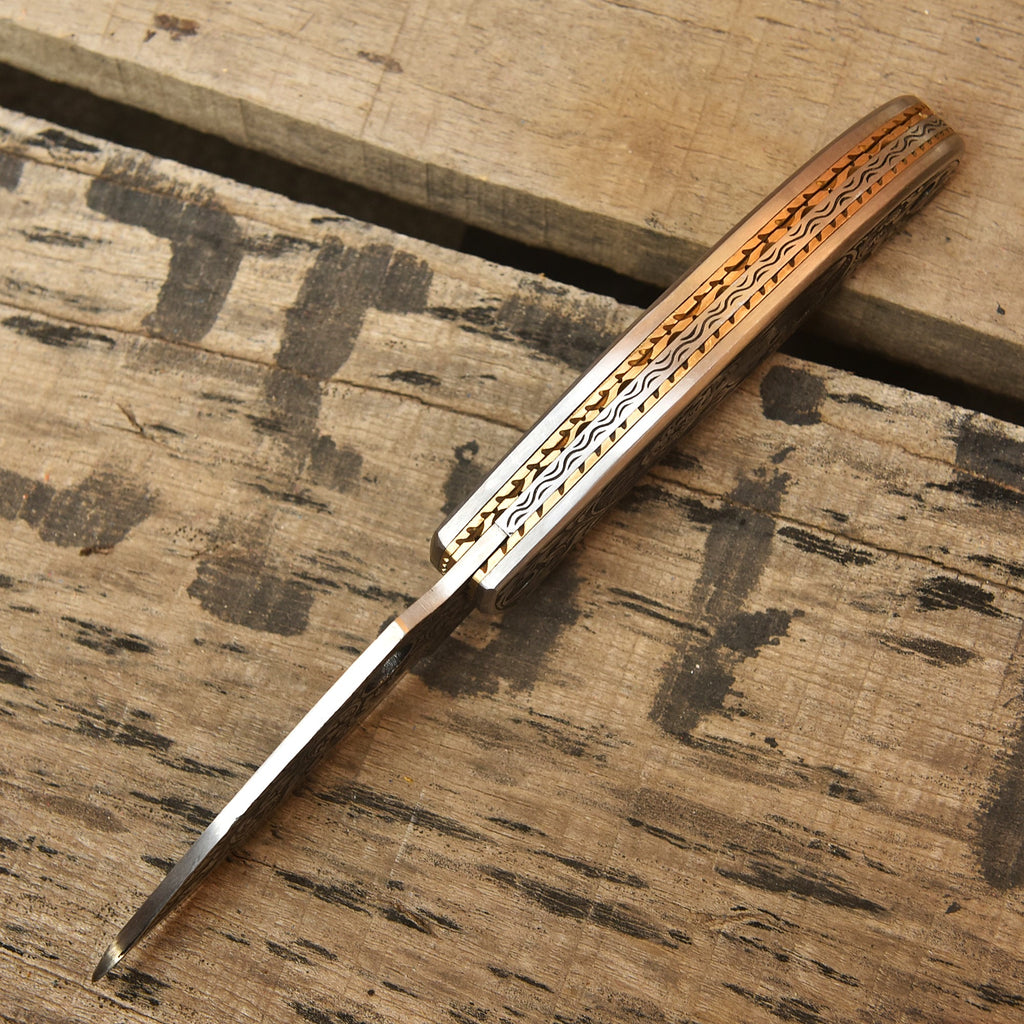 Skull engraved Damascus folding knife closed view