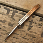Skull engraved Damascus folding knife closed view