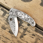 Close-up of skull engraving on Damascus knife handle
