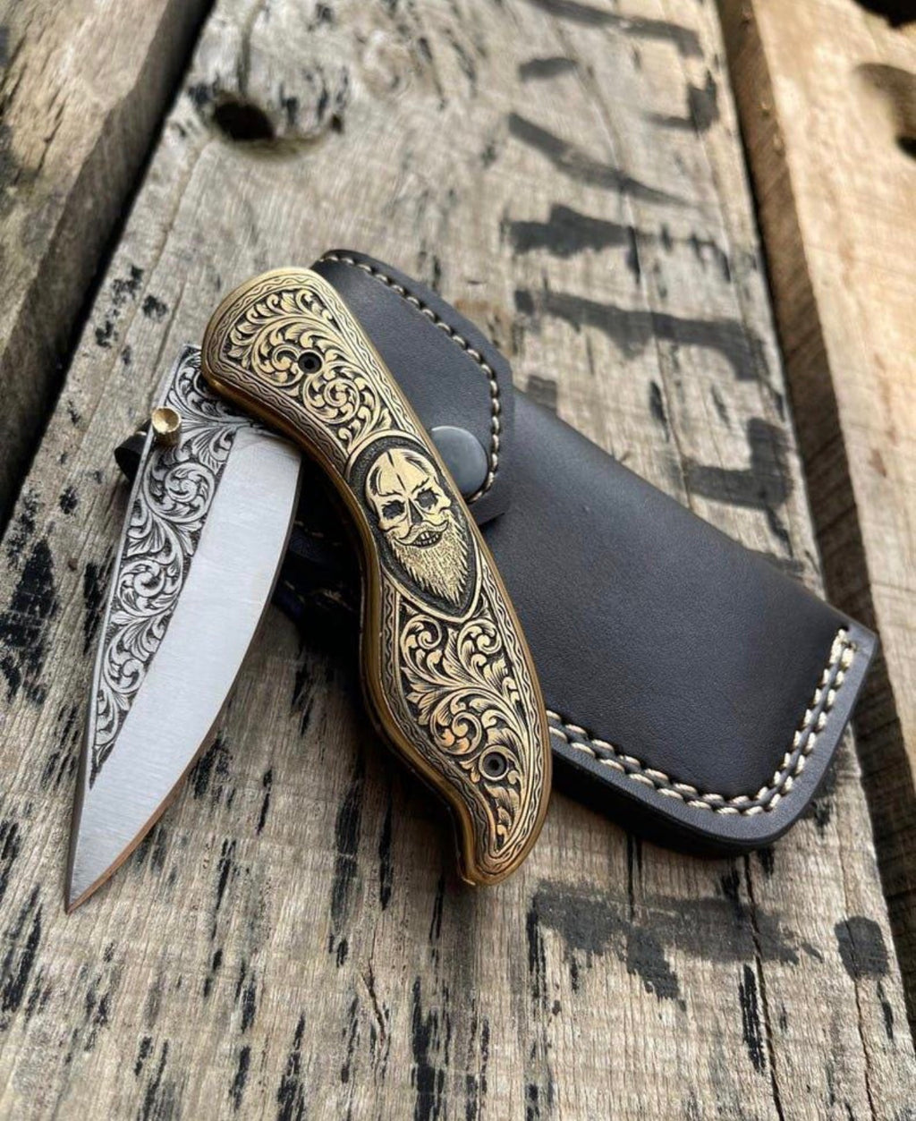 Skull folding knife with leather sheath