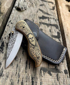 Skull folding knife with leather sheath