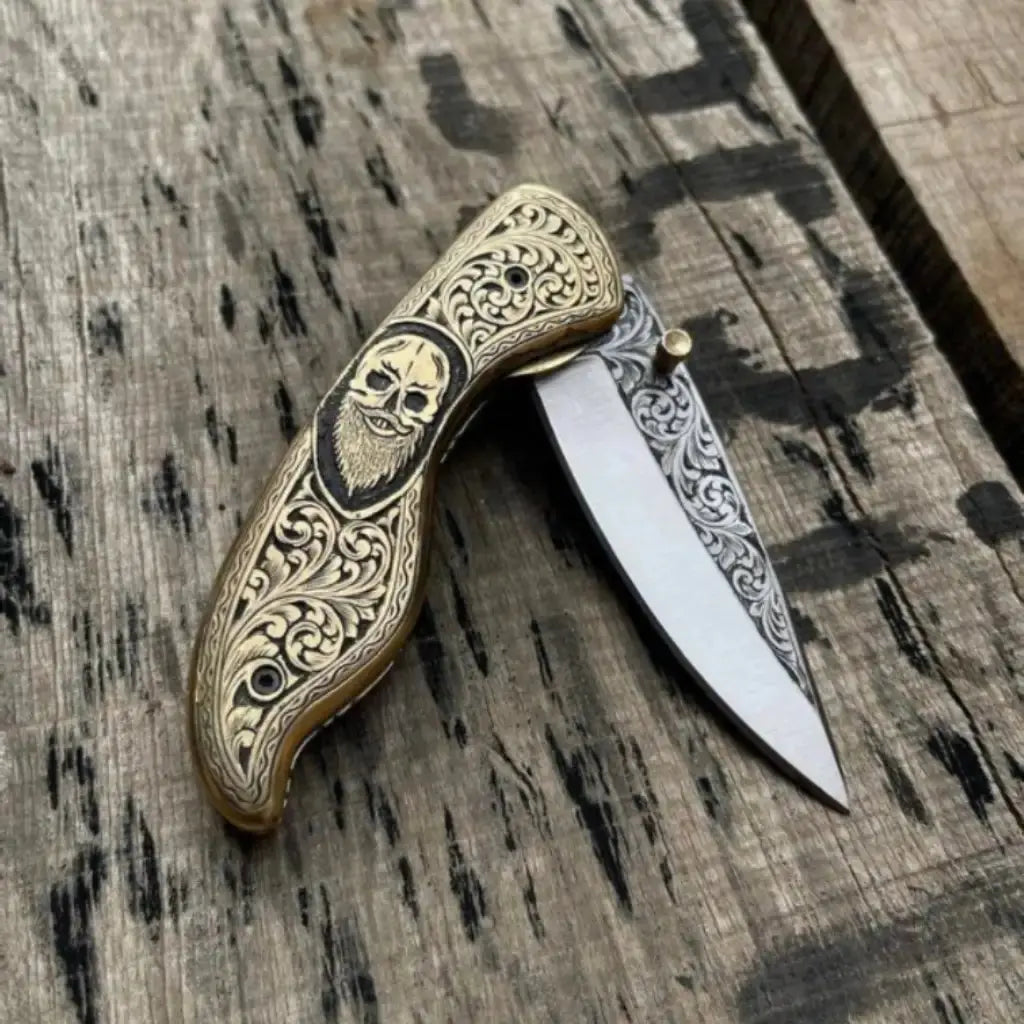 Skull handle folding pocket knife blade close-up