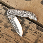 Steel folding knife handle grip detail